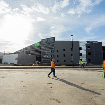 construction worker walking outside of a warehouse building