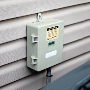 Load Control Receiver device attached to vinyl siding of a house