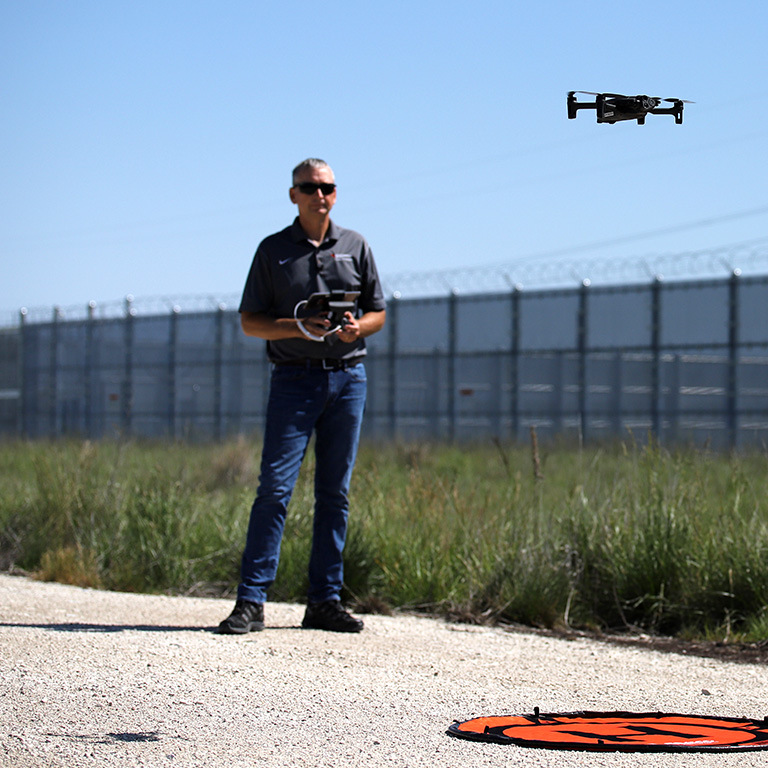 A MidAmerican drone pilot operating a drone