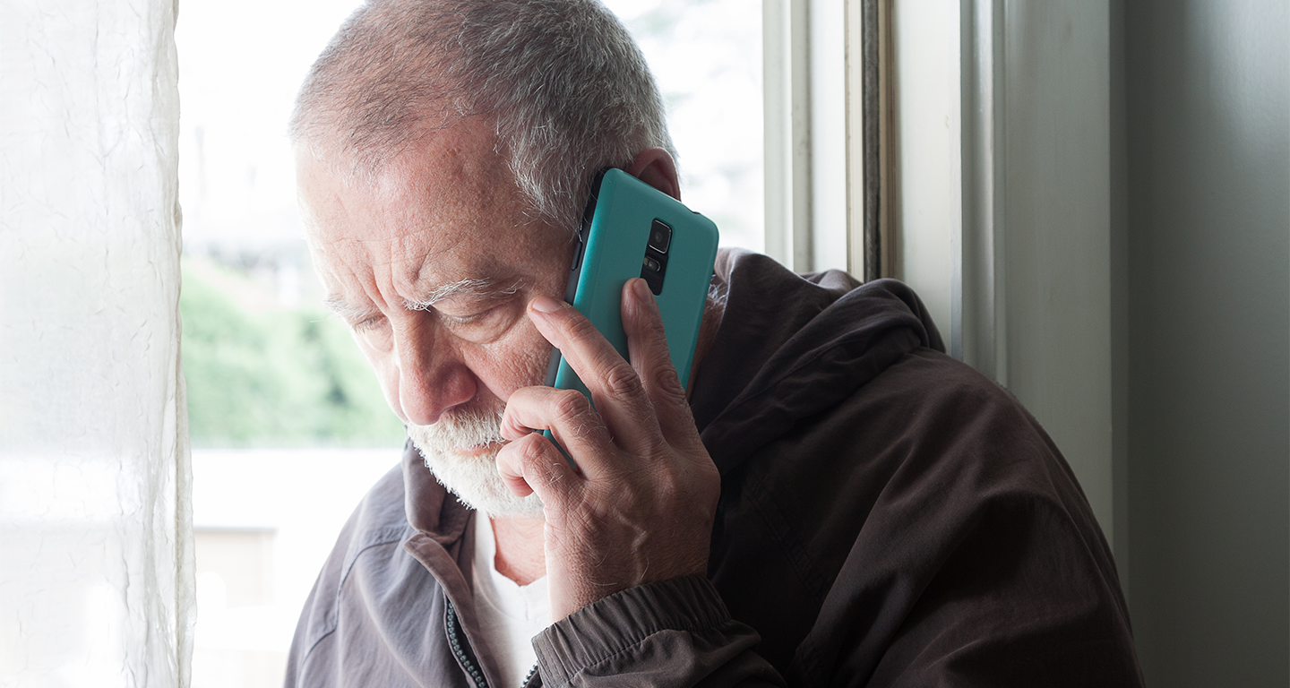 Concerned older man on cell phone